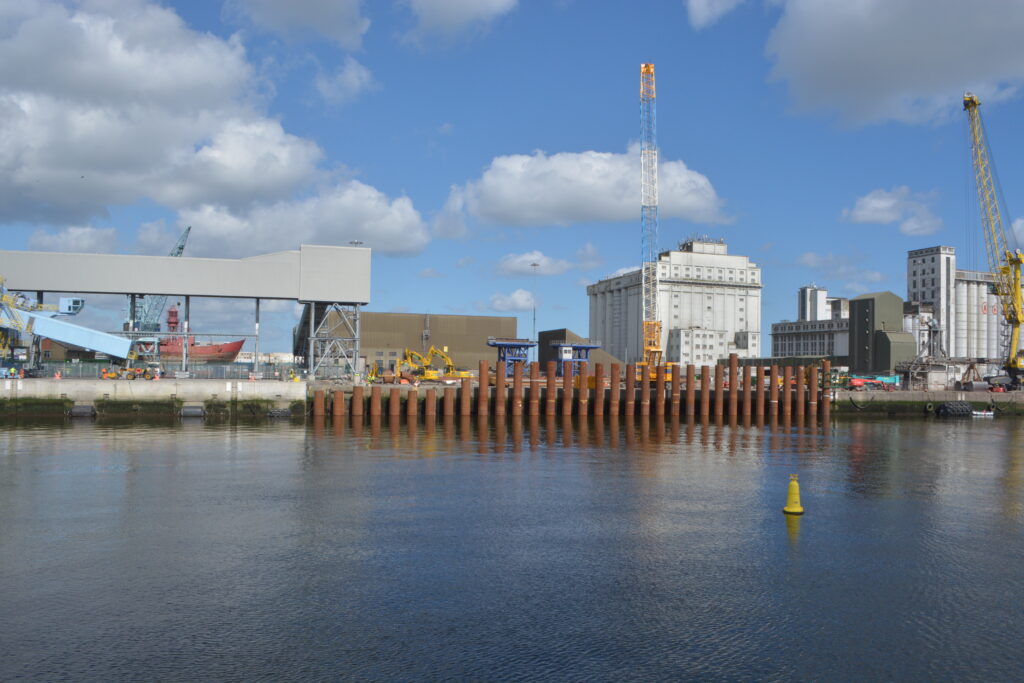 Dublin Port under construction with water in the foreground.