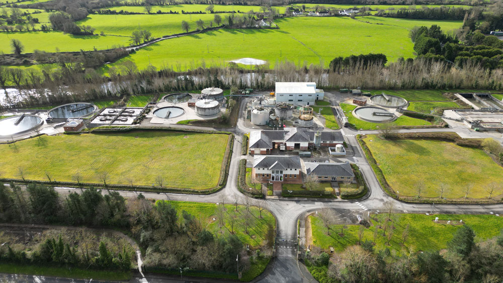 An aerial view of the Clonmel Waste Water Treatment Plant Aeration Basin surrounded by roads, fields and trees
