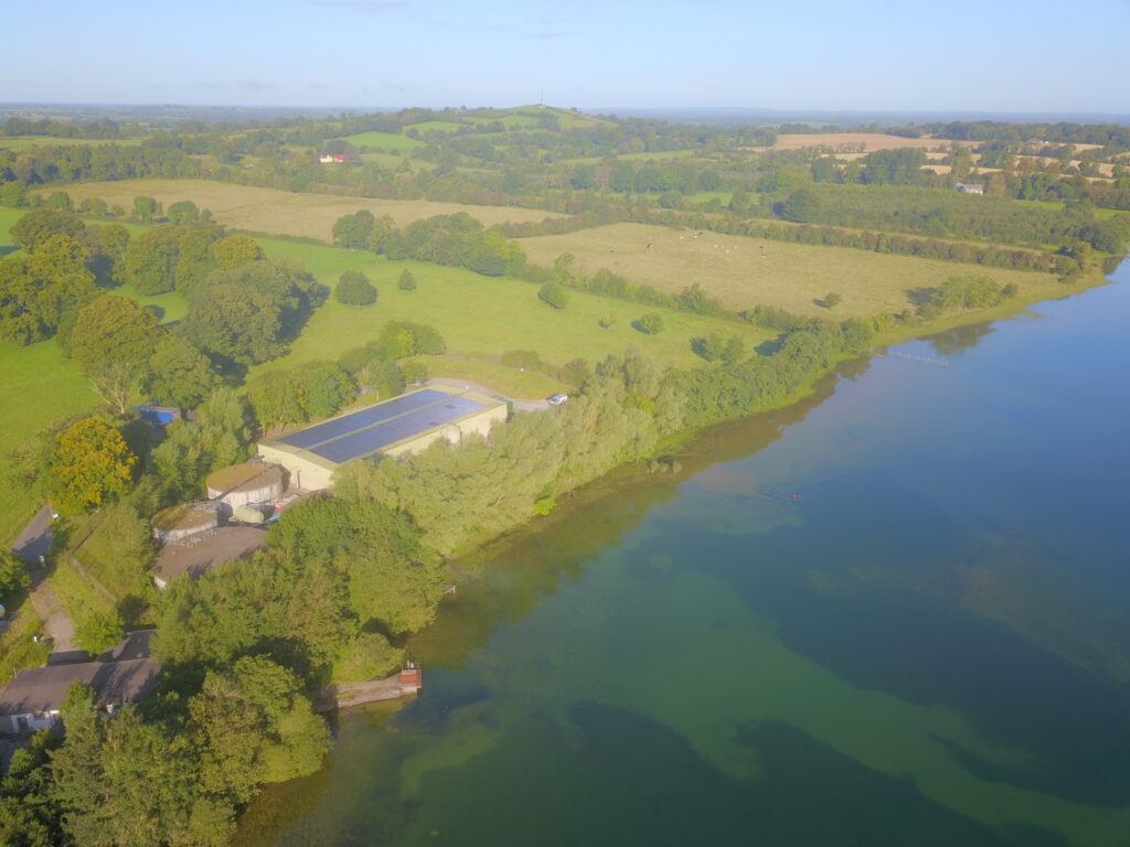 An aerial view of a water treatment plant in the countryside.