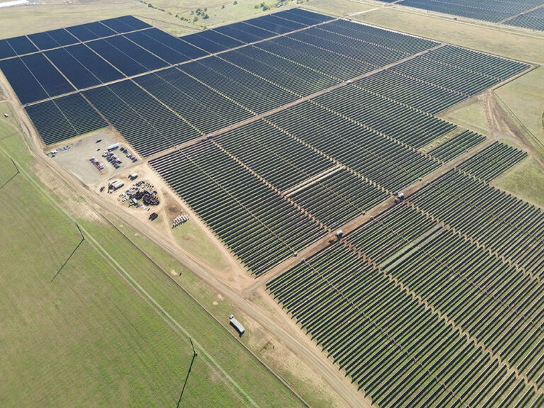 An aerial view of a solar farm surrounded by fields.