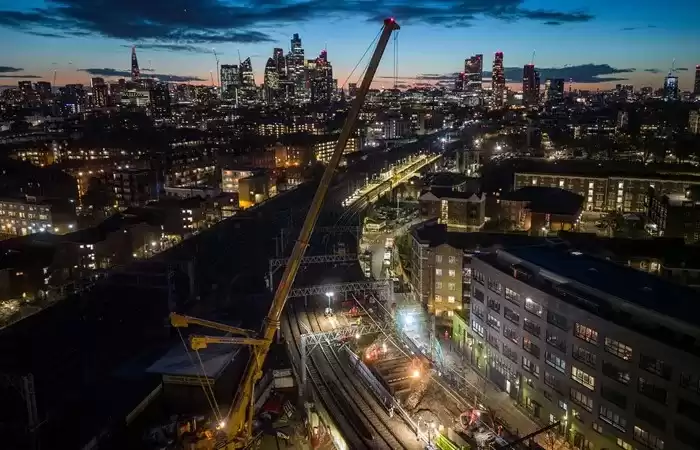 An aerial view of a cityscape and a railway under construction.