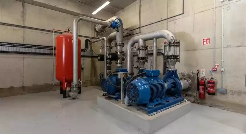 The inside of a water treatment plant with metal pipes and machinery
