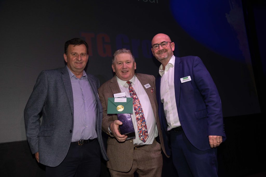 Three men smiling and celebrating an award win at the Murphy Supplier Awards 2024.