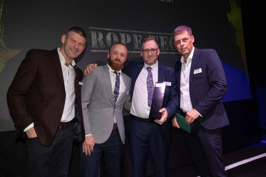 Four men in business dress celebrating an award win at the Murphy Supplier Awards.