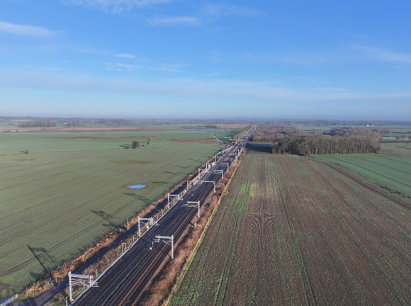 A railway track in the countryside on a bright day.