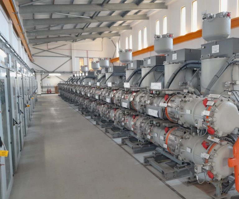 The interior of an energy substation showing machinery in a brightly lit room