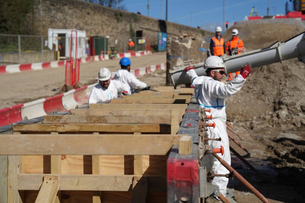 Murphy employees dressed in white safety uniform working on a construction site at Shipley Depot project site.